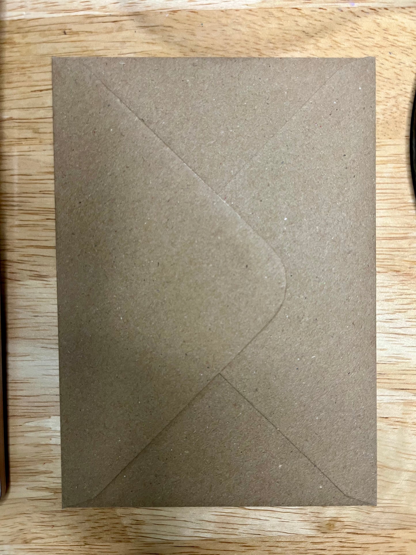 Brown envelope on a wooden surface