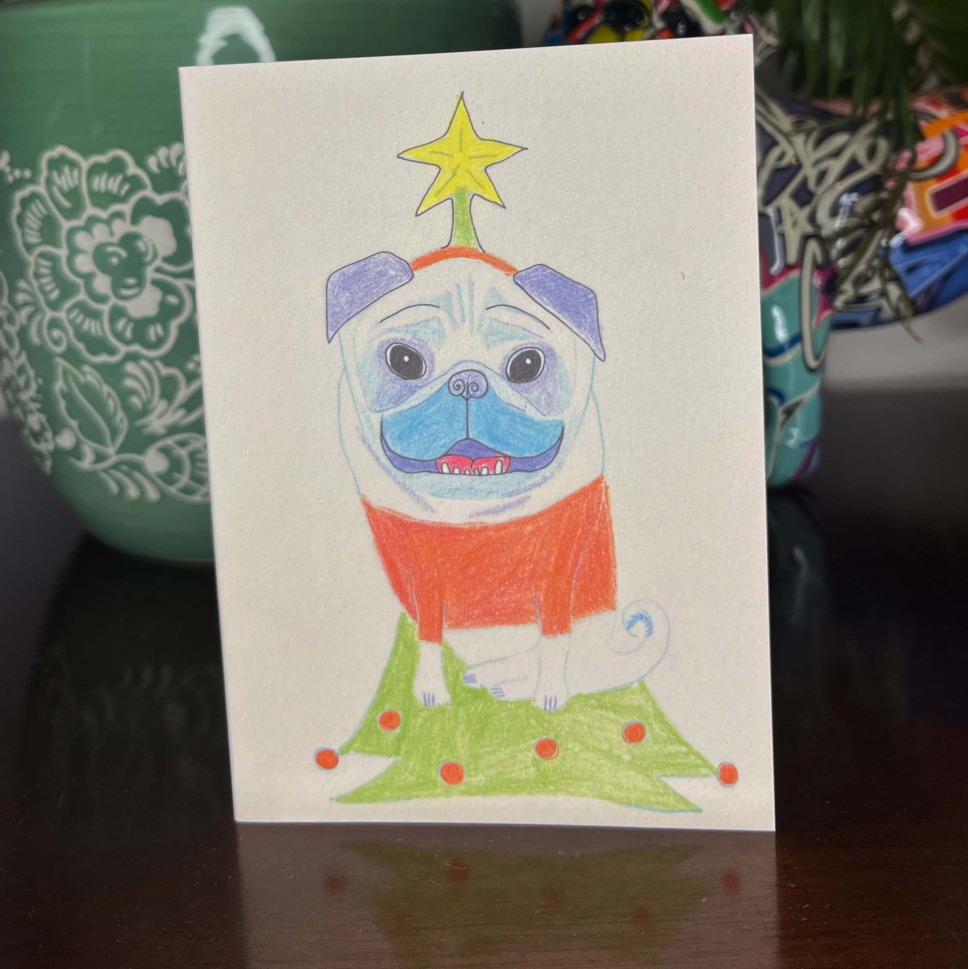 Colorful illustration of a pug on a card with decorative elements.